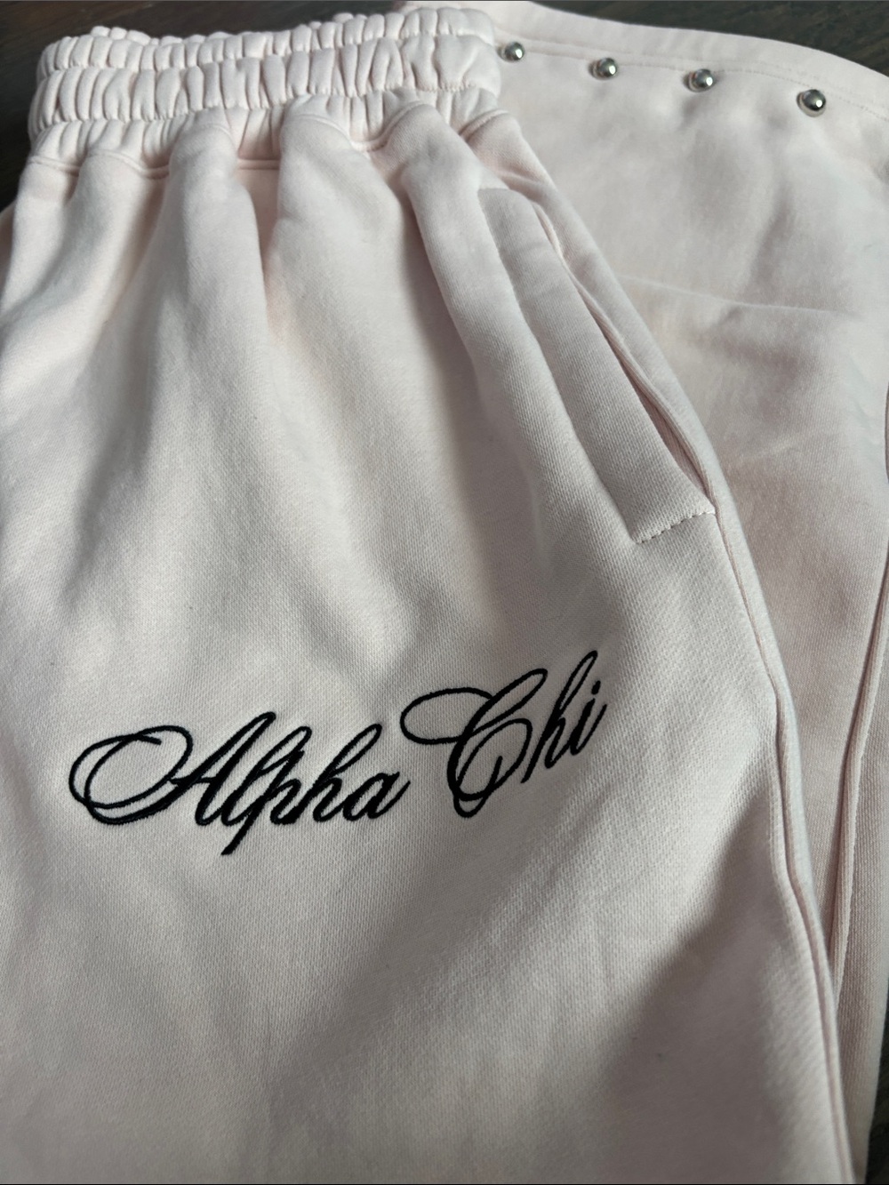 Alpha Chi Embroidered Light Pink Joggers with studs along bottoms